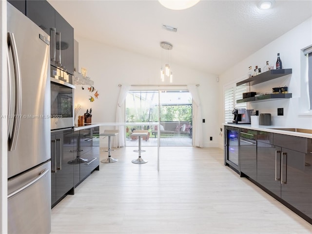 6110 Pitch Ln, Boynton Beach, FL 33437 - kitchen with appliances with stainless steel finishes, modern cabinets, vaulted ceiling, open shelves, and beverage cooler