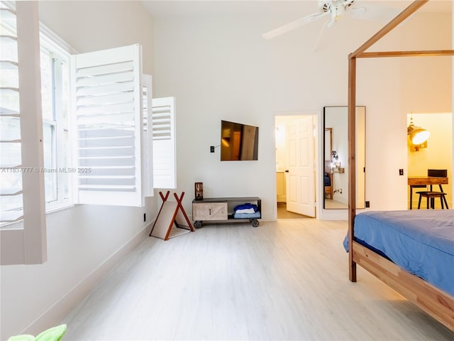 6110 Pitch Ln, Boynton Beach, FL 33437 - bedroom featuring multiple windows, wood finished floors, a towering ceiling, and a ceiling fan