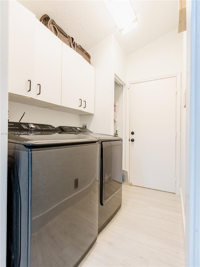 6110 Pitch Ln, Boynton Beach, FL 33437 - laundry area featuring cabinet space, independent washer and dryer, and light wood-style floors