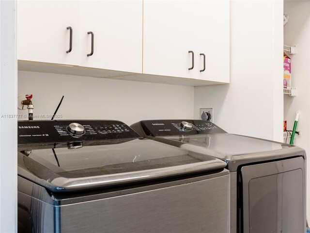 6110 Pitch Ln, Boynton Beach, FL 33437 - laundry room with washer and clothes dryer and cabinet space