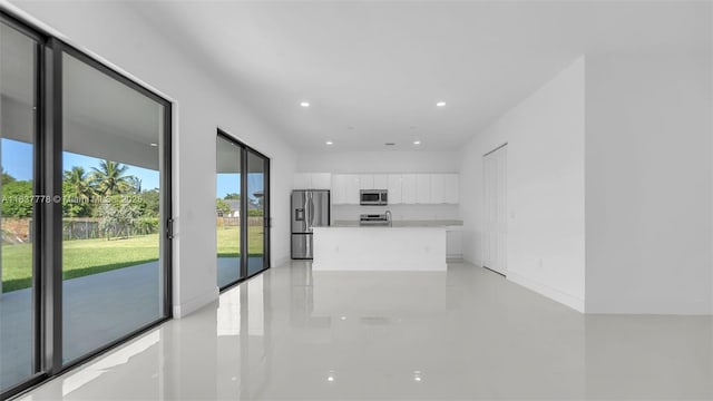 23120 SW 154th Ct, Miami, FL 33170 - kitchen with appliances with stainless steel finishes, white cabinets, modern cabinets, light tile patterned floors, and a kitchen island