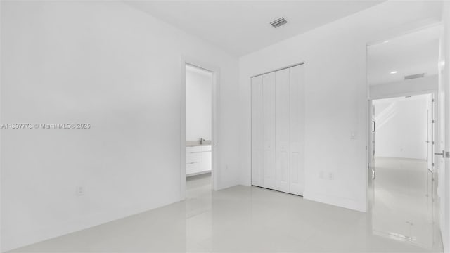 23120 SW 154th Ct, Miami, FL 33170 - unfurnished bedroom featuring a closet, light tile patterned flooring, recessed lighting, and ensuite bath