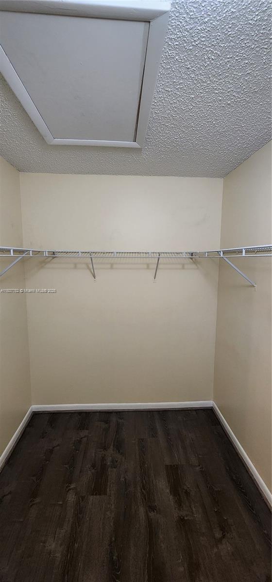 2957 Oak Park Cir, Davie, FL 33328 - spacious closet featuring dark wood-type flooring and attic access