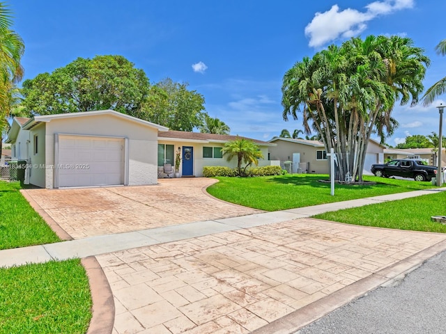 321 NW 93rd Ave, Pembroke Pines, FL 33024 - ranch-style home with decorative driveway, a garage, a front lawn, and stucco siding
