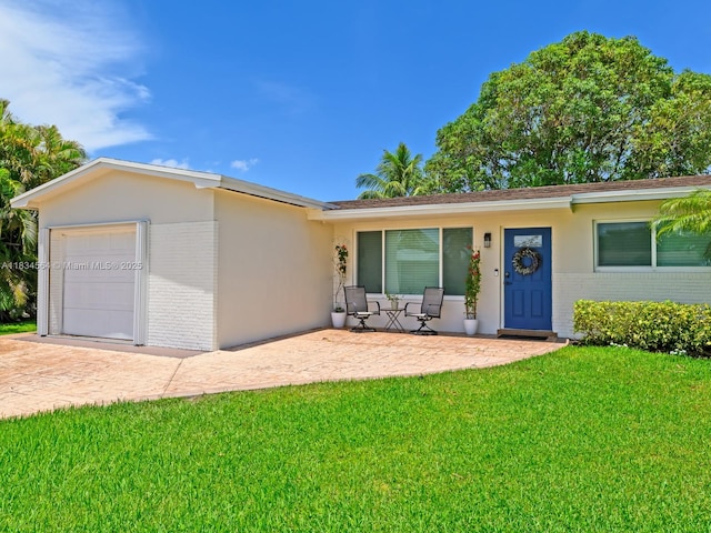 321 NW 93rd Ave, Pembroke Pines, FL 33024 - ranch-style home featuring brick siding, a front lawn, stucco siding, and driveway