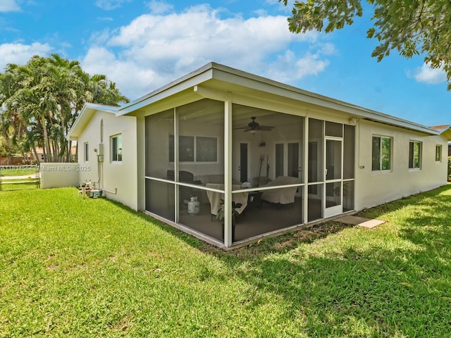 321 NW 93rd Ave, Pembroke Pines, FL 33024 - back of property featuring a sunroom, a yard, a ceiling fan, and stucco siding