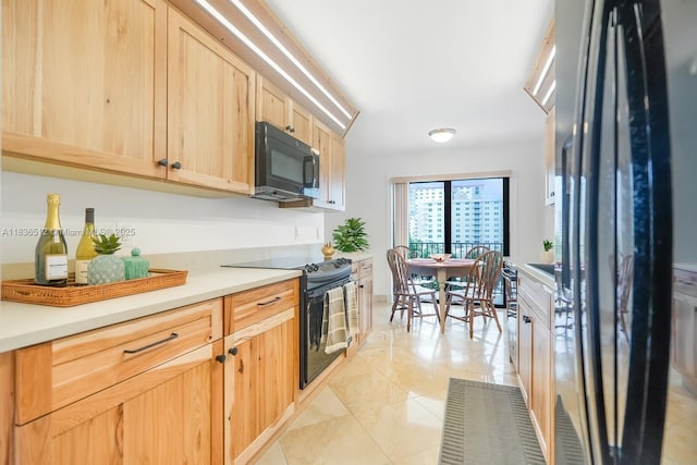 1201 S Ocean Dr Unit 410S, Hollywood, FL 33019 - kitchen featuring black appliances, light brown cabinetry, light countertops, and light tile patterned flooring