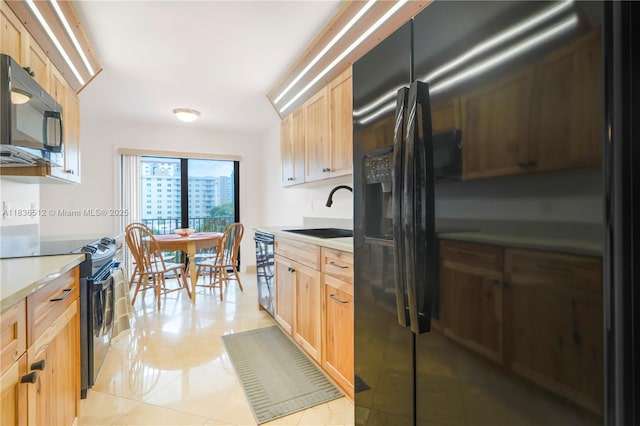 1201 S Ocean Dr Unit 410S, Hollywood, FL 33019 - kitchen featuring black appliances, light brown cabinetry, light countertops, and light tile patterned floors