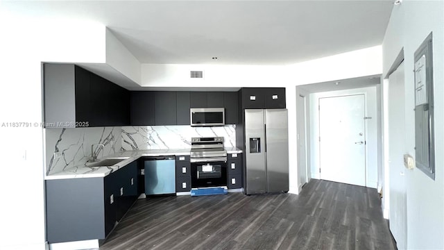 350 S Miami Ave Unit 2401, Miami, FL 33130 - kitchen featuring appliances with stainless steel finishes, dark cabinetry, light countertops, dark wood-style floors, and tasteful backsplash
