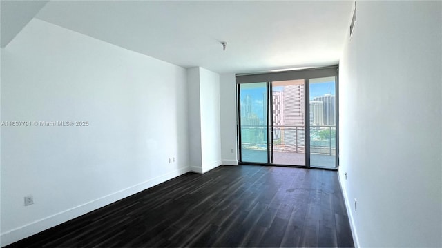 350 S Miami Ave Unit 2401, Miami, FL 33130 - unfurnished room with baseboards and dark wood finished floors