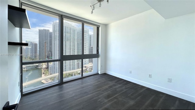 350 S Miami Ave Unit 2401, Miami, FL 33130 - empty room with a skyline view, dark wood finished floors, and track lighting