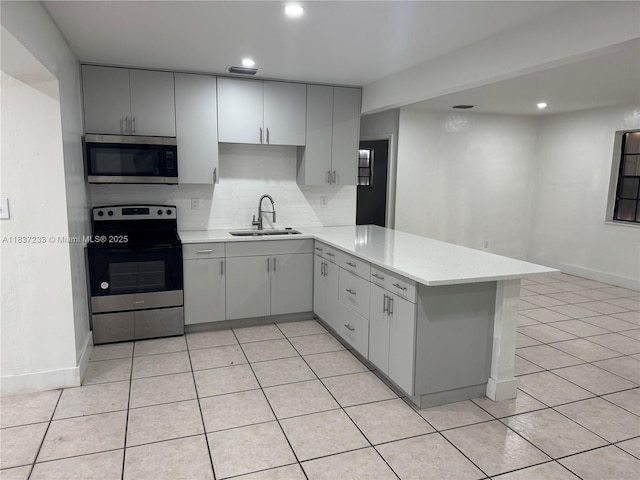 2855 SW 10th St, Fort Lauderdale, FL 33312 - kitchen featuring gray cabinets, stainless steel appliances, a peninsula, tasteful backsplash, and recessed lighting