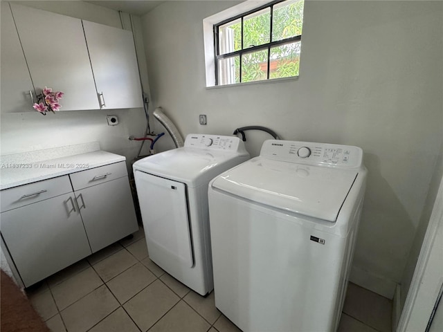 2855 SW 10th St, Fort Lauderdale, FL 33312 - laundry room featuring cabinet space, washer and clothes dryer, and light tile patterned floors