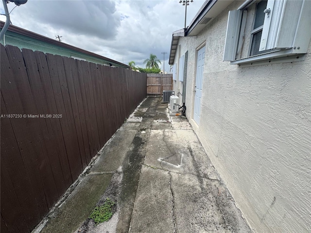 2855 SW 10th St, Fort Lauderdale, FL 33312 - view of side of property with stucco siding and an ac unit