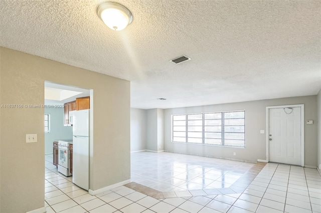 5640 NW 13th Ct, Lauderhill, FL 33313 - unfurnished room with light tile patterned flooring and a textured ceiling