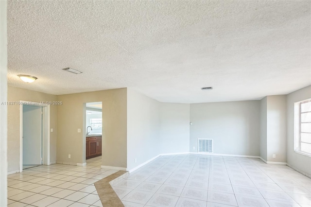 5640 NW 13th Ct, Lauderhill, FL 33313 - unfurnished room with light tile patterned floors and a textured ceiling