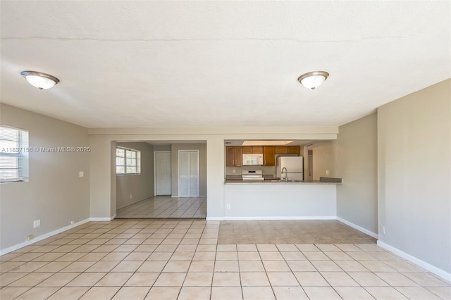 5640 NW 13th Ct, Lauderhill, FL 33313 - unfurnished living room featuring light tile patterned floors and baseboards