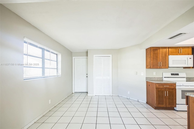 5640 NW 13th Ct, Lauderhill, FL 33313 - kitchen featuring white appliances, brown cabinetry, and light countertops