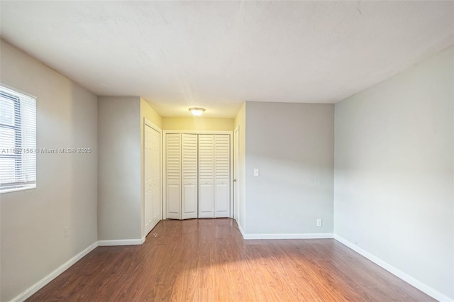 5640 NW 13th Ct, Lauderhill, FL 33313 - unfurnished bedroom with wood finished floors and a closet