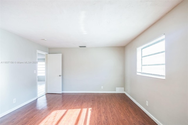5640 NW 13th Ct, Lauderhill, FL 33313 - empty room featuring wood finished floors and healthy amount of natural light