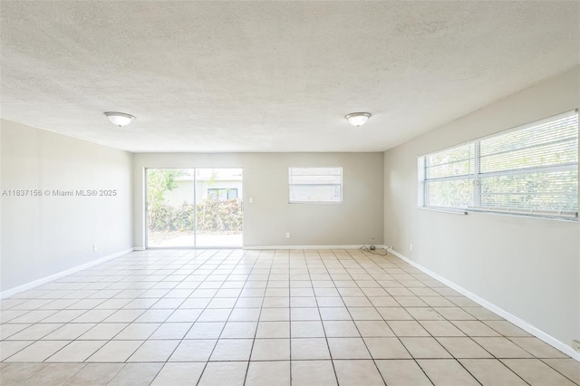 5640 NW 13th Ct, Lauderhill, FL 33313 - spare room with plenty of natural light, a textured ceiling, and light tile patterned floors