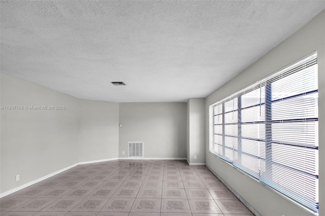 5640 NW 13th Ct, Lauderhill, FL 33313 - empty room featuring light tile patterned floors and a textured ceiling