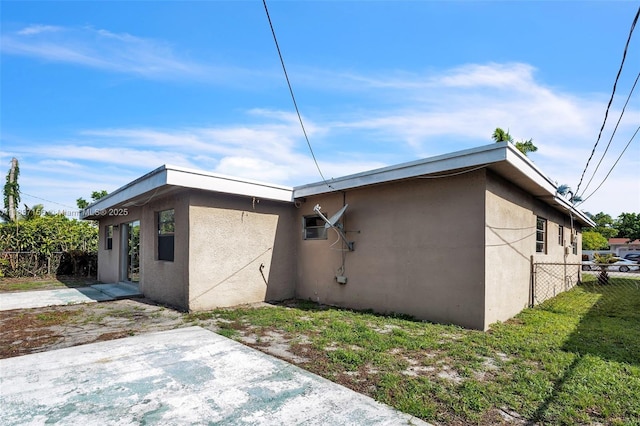 5640 NW 13th Ct, Lauderhill, FL 33313 - view of side of property featuring stucco siding and a patio area