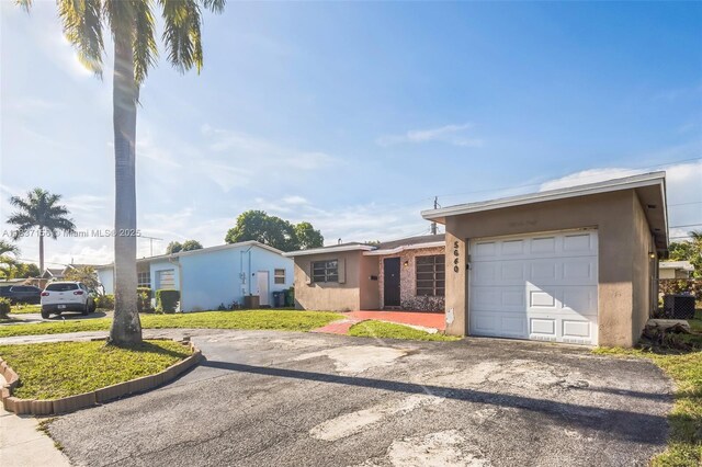 5640 NW 13th Ct, Lauderhill, FL 33313 - single story home featuring driveway, stucco siding, and a garage