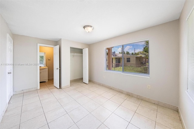312 SW 2nd Ter, Hallandale Beach, FL 33009 - unfurnished bedroom with a closet and light tile patterned flooring
