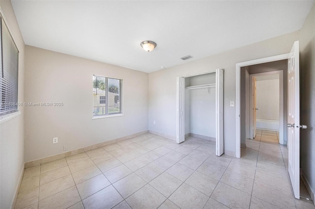 312 SW 2nd Ter, Hallandale Beach, FL 33009 - unfurnished bedroom featuring light tile patterned flooring and a closet