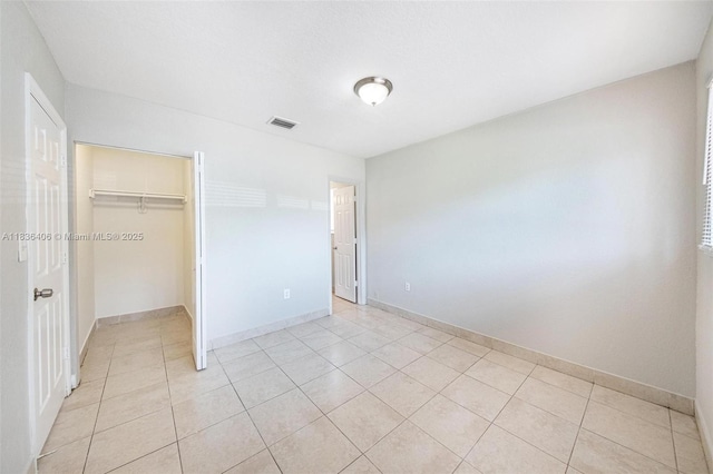 312 SW 2nd Ter, Hallandale Beach, FL 33009 - unfurnished bedroom with light tile patterned floors and a walk in closet