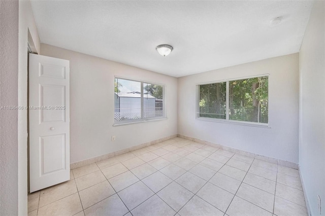 312 SW 2nd Ter, Hallandale Beach, FL 33009 - unfurnished room with light tile patterned flooring and baseboards