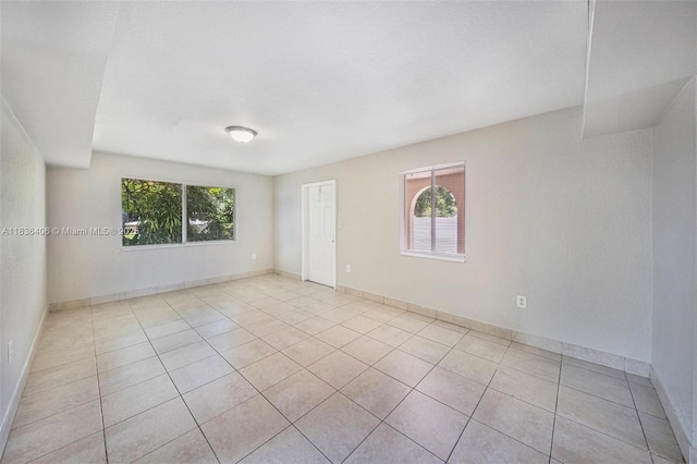 312 SW 2nd Ter, Hallandale Beach, FL 33009 - spare room with plenty of natural light and light tile patterned floors