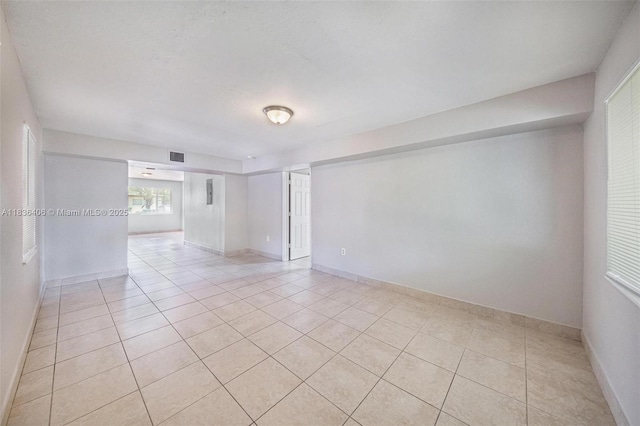 312 SW 2nd Ter, Hallandale Beach, FL 33009 - empty room with light tile patterned floors and baseboards