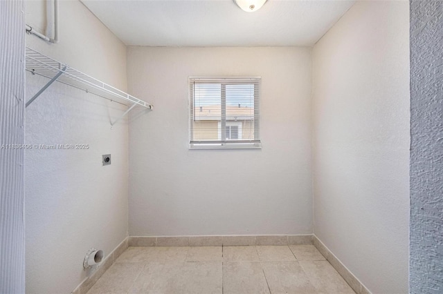 312 SW 2nd Ter, Hallandale Beach, FL 33009 - laundry room with hookup for an electric dryer and light tile patterned floors