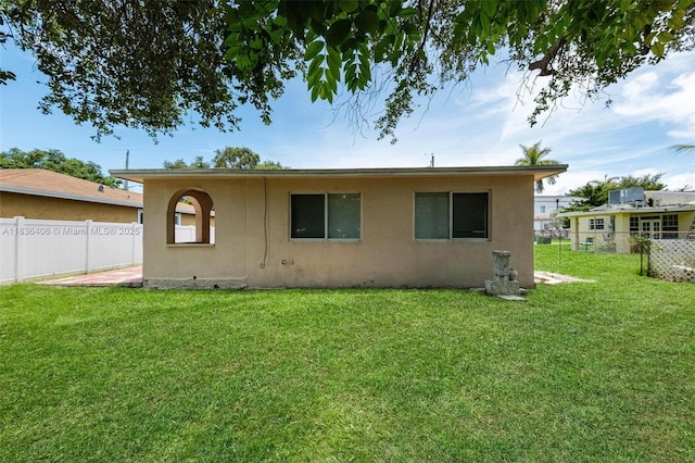 312 SW 2nd Ter, Hallandale Beach, FL 33009 - rear view of house with stucco siding and a fenced backyard