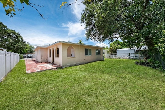 312 SW 2nd Ter, Hallandale Beach, FL 33009 - back of house featuring stucco siding, a fenced backyard, and a patio area