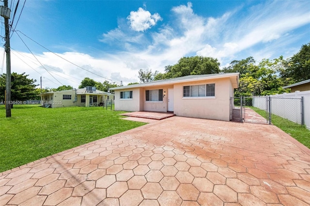 312 SW 2nd Ter, Hallandale Beach, FL 33009 - rear view of property with a gate, stucco siding, a patio, and decorative driveway