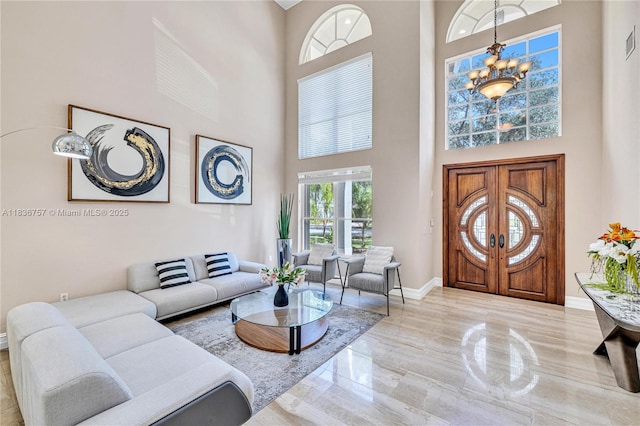 19480 SW 39th Ct, Miramar, FL 33029 - living room featuring a high ceiling, a chandelier, and marble tiled floors