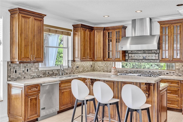 19480 SW 39th Ct, Miramar, FL 33029 - kitchen featuring wall chimney range hood, appliances with stainless steel finishes, brown cabinetry, and a textured ceiling