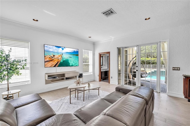 19480 SW 39th Ct, Miramar, FL 33029 - living room featuring ornamental molding, plenty of natural light, a textured ceiling, light wood-type flooring, and french doors