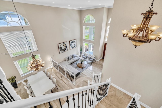 19480 SW 39th Ct, Miramar, FL 33029 - staircase featuring a chandelier, ornamental molding, recessed lighting, a towering ceiling, and arched walkways
