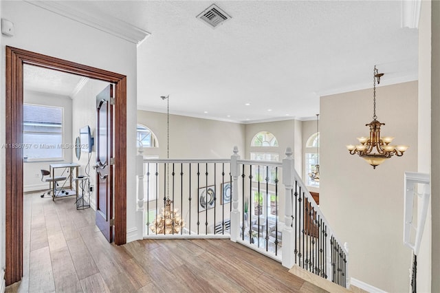 19480 SW 39th Ct, Miramar, FL 33029 - corridor featuring a chandelier, ornamental molding, plenty of natural light, wood finished floors, and an upstairs landing