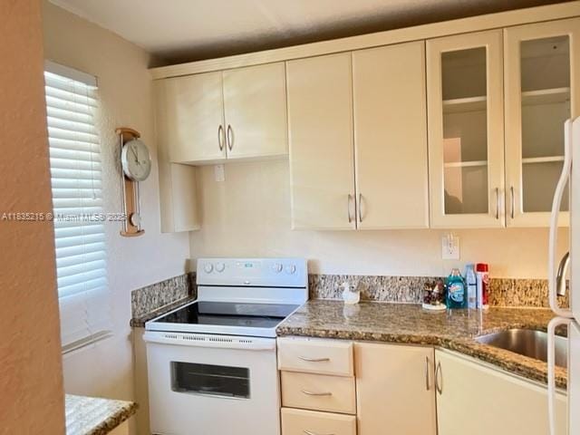 17255 SW 95th Ave Unit 202, Palmetto Bay, FL 33157 - kitchen featuring white appliances, stone countertops, and glass insert cabinets