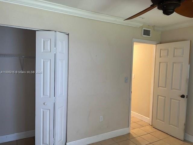 17255 SW 95th Ave Unit 202, Palmetto Bay, FL 33157 - unfurnished bedroom featuring ornamental molding, light tile patterned floors, a closet, and ceiling fan