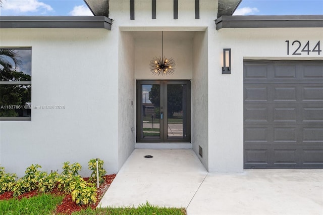 1244 NW 30th Ave, Fort Lauderdale, FL 33311 - property entrance with french doors, an attached garage, and stucco siding