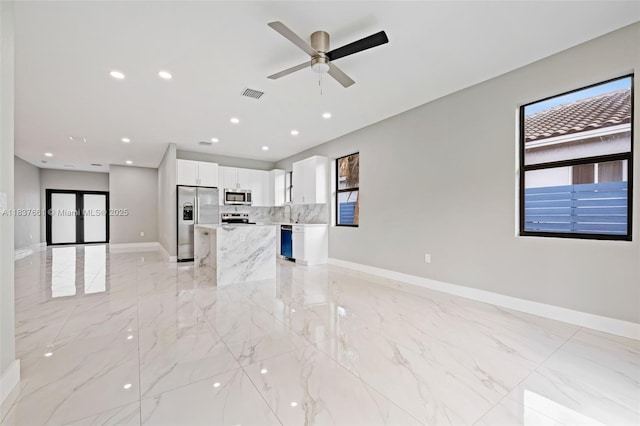 1244 NW 30th Ave, Fort Lauderdale, FL 33311 - unfurnished living room featuring healthy amount of natural light, light marble finish floors, ceiling fan, and recessed lighting