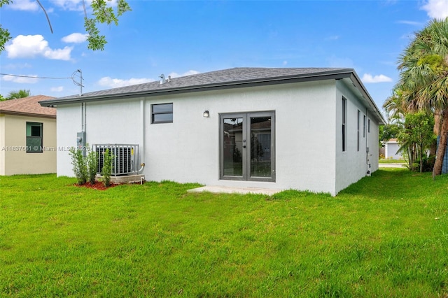 1244 NW 30th Ave, Fort Lauderdale, FL 33311 - rear view of house featuring a lawn and stucco siding