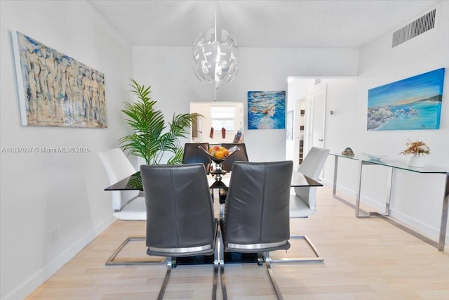 1501 S Ocean Blvd Unit 227, Lauderdale By The Sea, FL 33062 - dining space with wood finished floors and a chandelier
