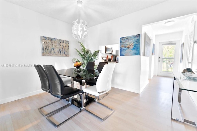 1501 S Ocean Blvd Unit 227, Lauderdale By The Sea, FL 33062 - dining area with a chandelier and wood finished floors